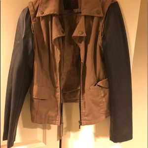 A Tan / Black Jacket With Black Leather Sleeves
